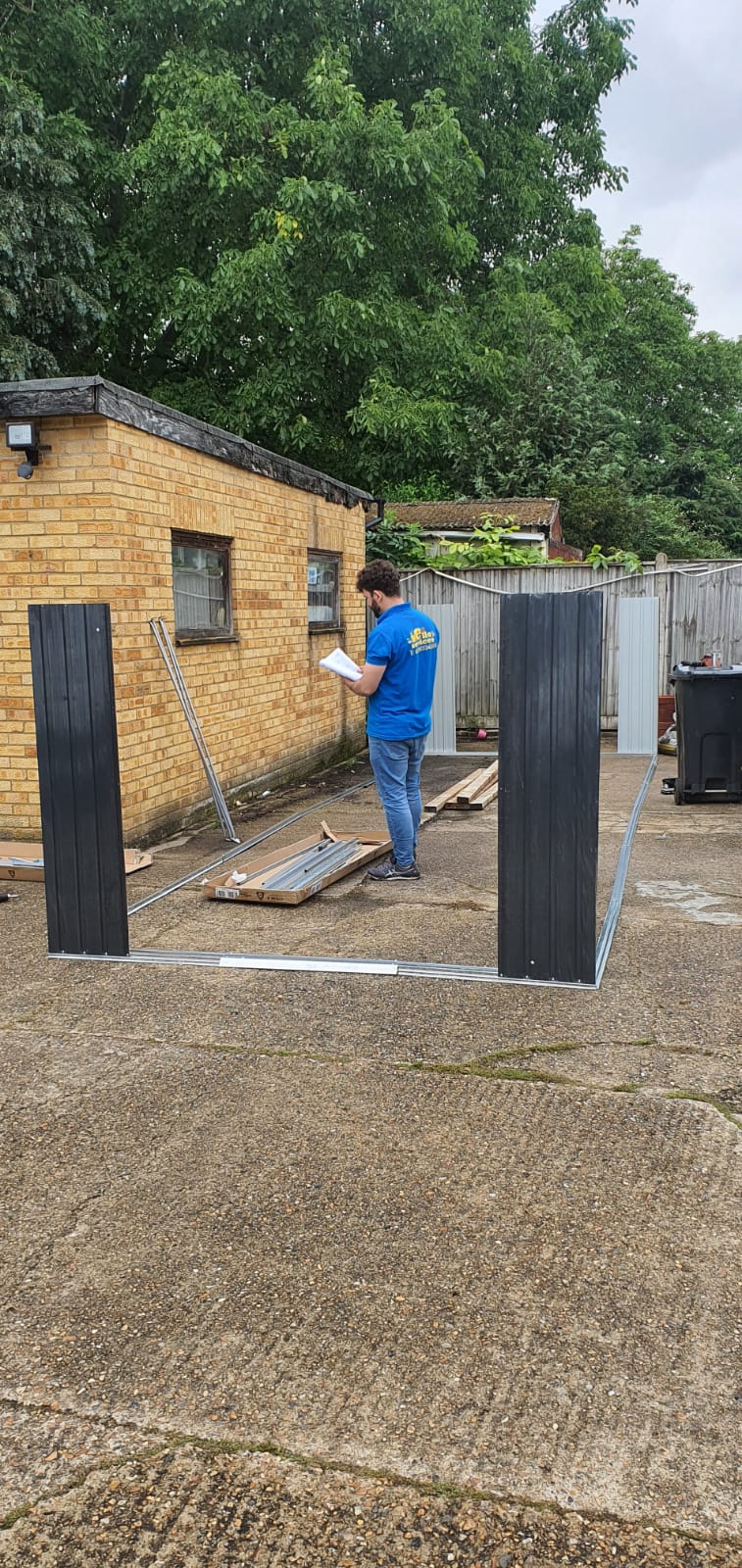 Professional securing roof felt on a sturdy wooden garden shed